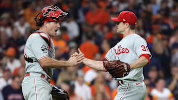 Oct 28, 2022; Houston, Texas, USA; Philadelphia Phillies relief pitcher David Robertson (30) and catcher J.T. Realmuto (left) celebrate on the field after defeating the Houston Astros during game one of the 2022 World Series at Minute Maid Park. Mandatory Credit: Erik Williams-Imagn Images