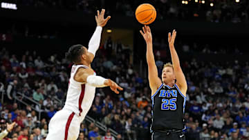 Mar 27, 2025; Newark, NJ, USA; Brigham Young Cougars guard Dawson Baker (25) shoots the ball against Alabama Crimson Tide forward Jarin Stevenson (15) during the second half during an East Regional semifinal of the 2025 NCAA tournament at Prudential Center. Mandatory Credit: Robert Deutsch-Imagn Images