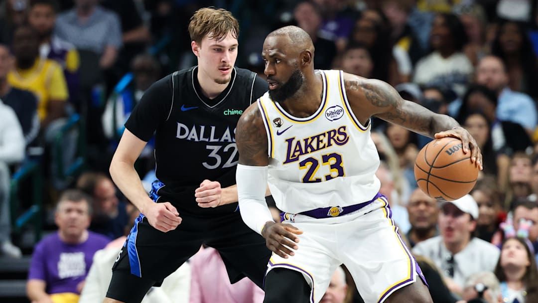 Apr 5, 2026; Dallas, Texas, USA;  Los Angeles Lakers forward LeBron James (23) controls the ball as  Dallas Mavericks forward Cooper Flagg (32) defends 