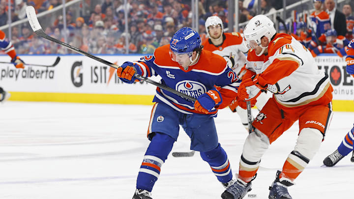 Mar 28, 2026; Edmonton, Alberta, CAN; Edmonton Oilers forward Matt Savoie (22) and Anaheim Ducks defensemen John Carlson (74) battle for a loose puck during the third period at Rogers Place. Mandatory Credit: Perry Nelson-Imagn Images