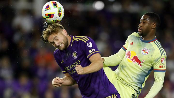 Nov 30, 2024; Orlando, Florida, USA; New York Red Bulls defender Andres Reyes (4) is called for a high kick against Orlando City forward Duncan McGuire (13) during the second half in the 2024 MLS Cup Eastern Conference Final match at Inter&Co Stadium. Mandatory Credit: Morgan Tencza-Imagn Images
