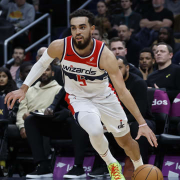 Jan 25, 2024; Washington, District of Columbia, USA; Washington Wizards guard Tyus Jones (5) drives to the basket as Utah Jazz guard Kris Dunn (11) defends in the first half at Capital One Arena. Mandatory Credit: Geoff Burke-USA TODAY Sports
