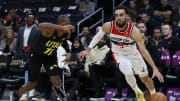 Jan 25, 2024; Washington, District of Columbia, USA; Washington Wizards guard Tyus Jones (5) drives to the basket as Utah Jazz guard Kris Dunn (11) defends in the first half at Capital One Arena. Mandatory Credit: Geoff Burke-USA TODAY Sports