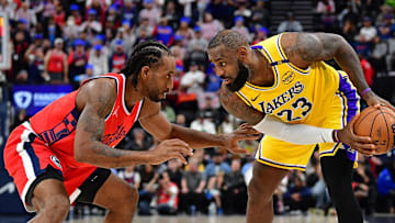 Feb 4, 2025; Inglewood, California, USA; Los Angeles Lakers forward LeBron James (23) controls the ball against Los Angeles Clippers forward Kawhi Leonard (2) during the second half at Intuit Dome. Mandatory Credit: Gary A. Vasquez-Imagn Images
