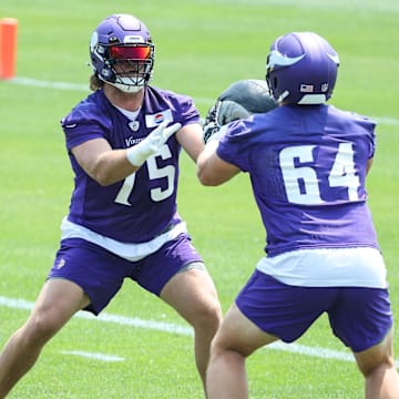 Jun 10, 2025; Minneapolis, MN, USA; Minnesota Vikings offensive tackle Brian O'Neill (75) and guard Blake Brandel (64) practice during minicamp at the Minnesota Vikings Training Facility.
