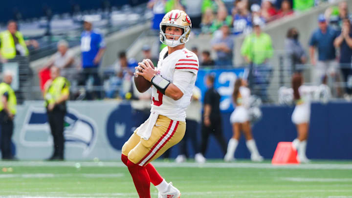 Sep 7, 2025; Seattle, Washington, USA; San Francisco 49ers quarterback Brock Purdy (13) looks to pass against the Seattle Seahawks during the third quarter at Lumen Field. Mandatory Credit: Joe Nicholson-Imagn Images