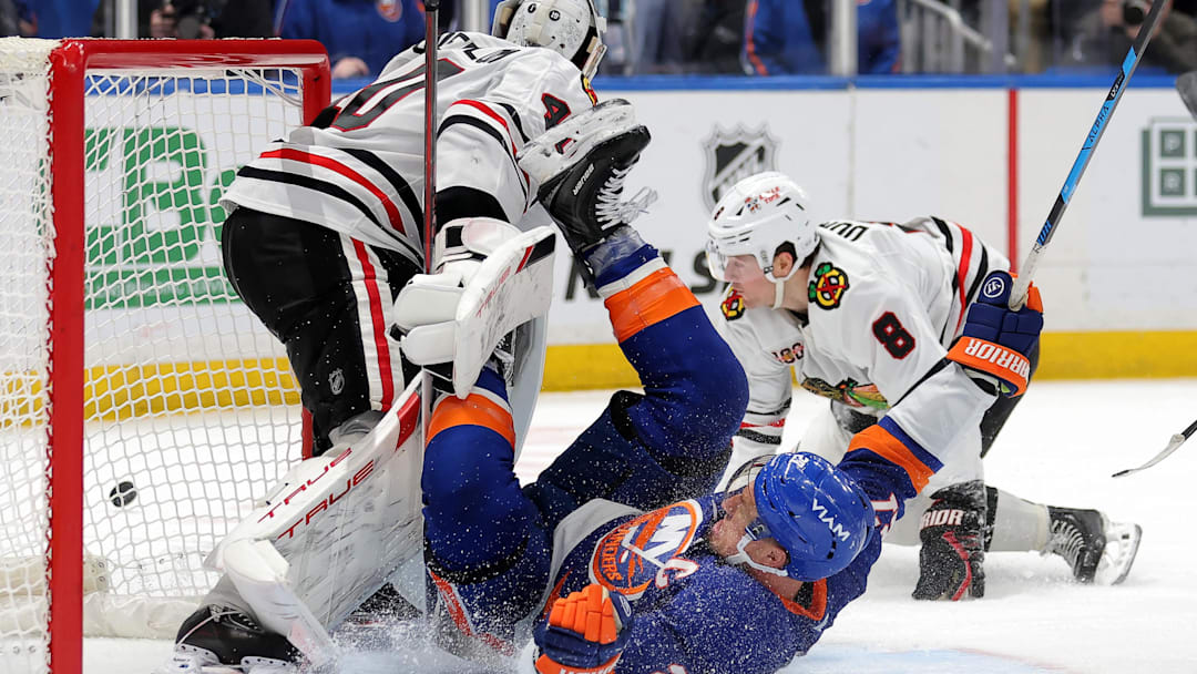 Mar 24, 2026; Elmont, New York, USA; New York Islanders left wing Anders Lee (27) slides into Chicago Blackhawks goaltender Arvid Soderblom (40) after being tripped by Blackhawks center Ryan Donato (8) during the third period at UBS Arena. Mandatory Credit: Brad Penner-Imagn Images