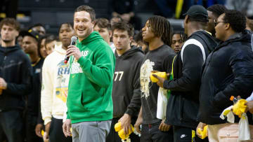 Oregon head football coach Dan Lanning and his team address the crowd during a timeout of an Oregon basketball game.