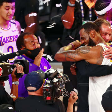 Oct 11, 2020; Lake Buena Vista, Florida, USA; Los Angeles Lakers forward LeBron James (23) hugs general manager Rob Pelinka after game six of the 2020 NBA Finals at AdventHealth Arena. The Los Angeles Lakers won 106-93 to win the series. Mandatory Credit: Kim Klement-USA TODAY Sports