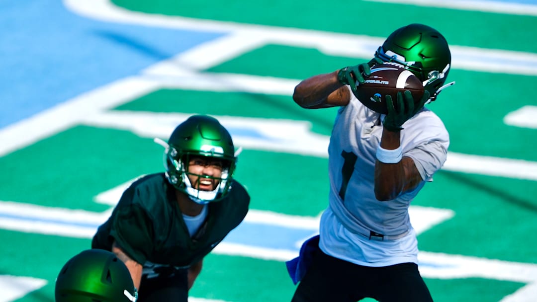 Dontae Fleming (1 in white) makes a touchdown grab during Fall Camp.