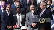 Apr 10, 2018; Washington, DC, USA; President Donald Trump gestures as Alabama Crimson Tide head coach Nick Saban (L) smiles at a ceremony honoring the college football playoff champion Crimson Tide on the South Lawn at the White House. Mandatory Credit: Geoff Burke-Imagn Images