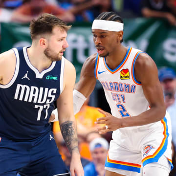 May 11, 2024; Dallas, Texas, USA; Dallas Mavericks guard Luka Doncic (77) controls the ball as Oklahoma City Thunder guard Shai Gilgeous-Alexander (2) defends during the second half during game three of the second round for the 2024 NBA playoffs at American Airlines Center. Mandatory Credit: Kevin Jairaj-USA TODAY Sports