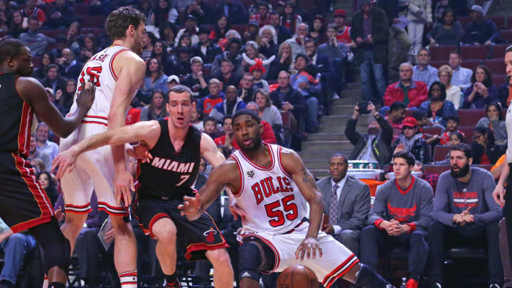 Chicago Bulls guard E'Twaun Moore (55) slips while driving around Miami Heat guard Goran Dragic (7) during the first quarter at the United Center. Mandatory Credit: Dennis Wierzbicki-USA TODAY Sports