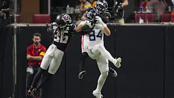Aug 15, 2025; Atlanta, Georgia, USA; Tennessee Titans tight end Gunnar Helm (84) catches a touchdown pass defended by Atlanta Falcons safety Jordan Fuller (29) and safety Ronnie Harrison (36) during the first half at Mercedes-Benz Stadium. Mandatory Credit: Dale Zanine-Imagn Images