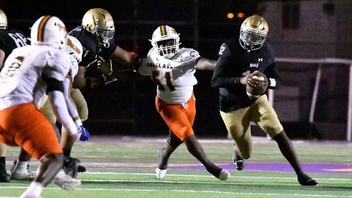 Male runs through an opening in the Frederick Douglass line during the second half of their game, Friday, Oct. 3 2025 in Louisville Ky. Frederic Douglass won 14-0.