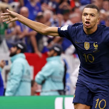 Dec 18, 2022; Lusail, Qatar; France forward Kylian Mbappe (10) celebrates after scoring a goal against Argentina on a penalty kick for his third goal of the match during extra time of the 2022 World Cup final at Lusail Stadium. Mandatory Credit: Yukihito Taguchi-Imagn Images