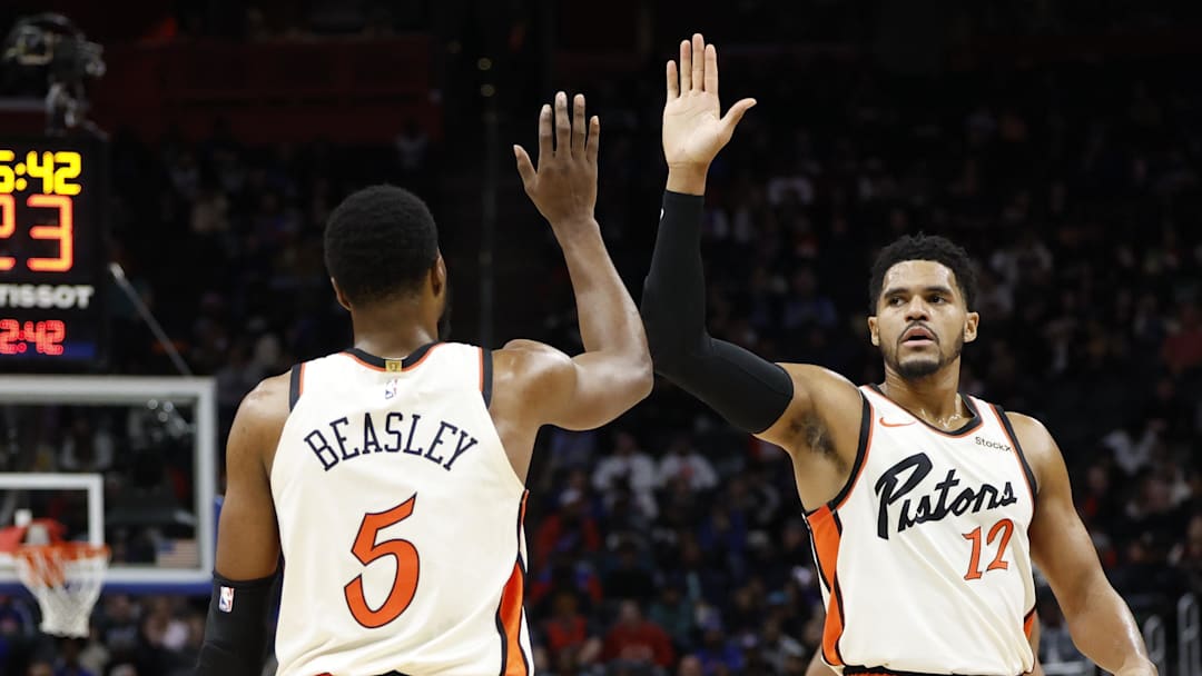 Nov 25, 2024; Detroit, Michigan, USA;  Detroit Pistons guard Malik Beasley (5) and forward Tobias Harris (12) celebrates in the first half against the Toronto Raptors at Little Caesars Arena. Mandatory Credit: Rick Osentoski-Imagn Images