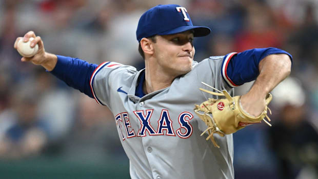 Texas Rangers starting pitcher Jack Leiter throws a pitch in a gray uniform and blue hat
