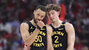 May 4, 2025; Houston, Texas, USA; Golden State Warriors guard Stephen Curry (30) and guard Brandin Podziemski (2) talk during a timeout during game seven of first round for the 2025 NBA Playoffs against the Houston Rockets at Toyota Center. Mandatory Credit: Troy Taormina-Imagn Images