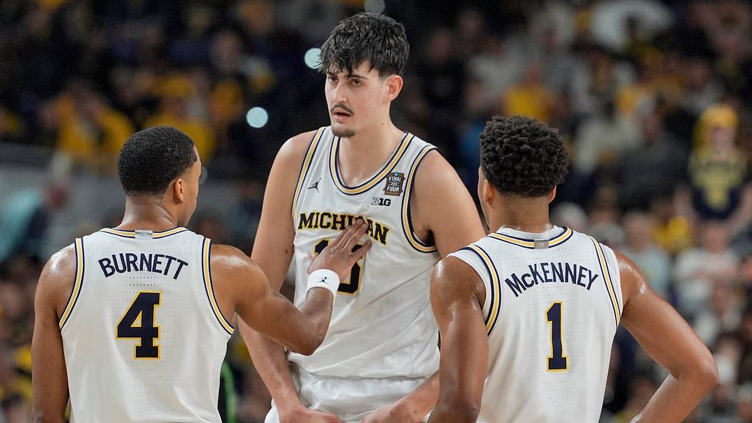 Michigan center Aday Mara (15) talks with Michigan guard Nimari Burnett (4) and Michigan guard Trey McKenney (1) during the first half of the NCAA national championship game against Connecticut at Lucas Oil Stadium in Indianapolis on Monday, April 6, 2026. Michigan center Aday Mara (15) talks with Michigan guard Nimari Burnett (4) and Michigan guard Trey McKenney (1) during the first half of the NCAA national championship game against Connecticut at Lucas Oil Stadium in Indianapolis on Monday, April 6, 2026.