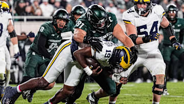 Michigan State defensive lineman Alex VanSumeren (91) tackles Michigan quarterback Bryce Underwood (19) during the second half at Spartan Stadium in East Lansing on Saturday, October 25, 2025.
