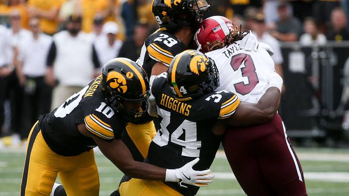 Iowa’s Nick Jackson (10), Jay Higgins (34) and Sebastian Castro (29) tackle Troy’s running back Damien Taylor (3) Saturday, Sept. 14, 2024 at Kinnick Stadium in Iowa City, Iowa.
