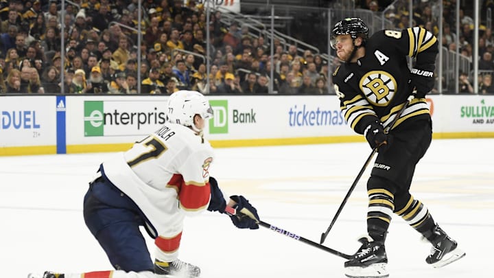 May 12, 2024; Boston, Massachusetts, USA; Boston Bruins right wing David Pastrnak (88) passes the puck past Florida Panthers defenseman Niko Mikkola (77) during the third period in game four of the second round of the 2024 Stanley Cup Playoffs at TD Garden. Mandatory Credit: Bob DeChiara-Imagn Images