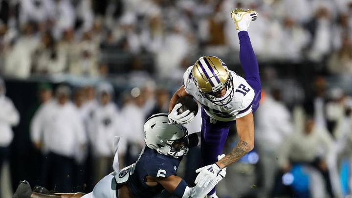 Nov 9, 2024; University Park, Pennsylvania, USA; Washington Huskies wide receiver Denzel Boston (12) runs with the ball against Penn State Nittany Lions safety Zakee Wheatley (6)  during the first quarter at Beaver Stadium. Mandatory Credit: Matthew O'Haren-Imagn Images