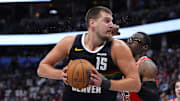 Nov 17, 2025; Denver, Colorado, USA;  Chicago Bulls forward/center Jalen Smith (25) defends on Denver Nuggets center Nikola Jokic (15) in the second half at Ball Arena.