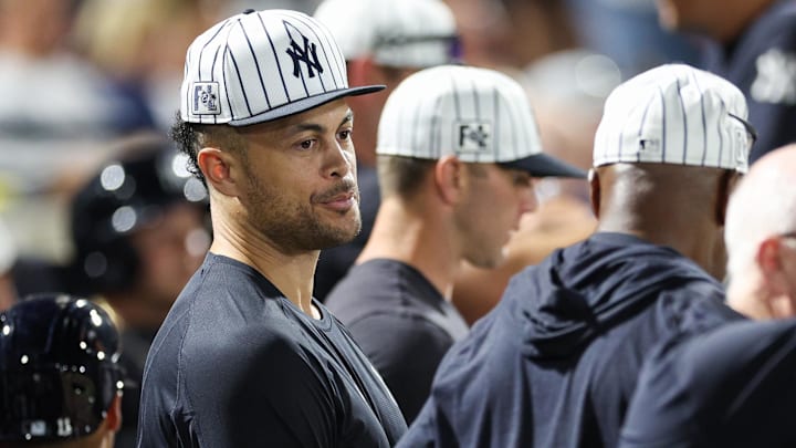 Mar 14, 2025; Tampa, Florida, USA; New York Yankees designated hitter Giancarlo Stanton (27) looks on from the dugout against the Philadelphia Phillies in the sixth inning during spring training at George M. Steinbrenner Field.