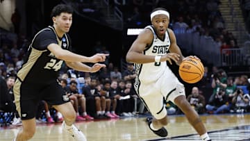 Mar 21, 2025; Cleveland, OH, USA; Michigan State Spartans guard Tre Holloman (5) dribbles defended by Bryant University Bulldogs guard Rafael Pinzon (24) in the second half during the NCAA Tournament First Round at Rocket Mortgage Fieldhouse. Mandatory Credit: Rick Osentoski-Imagn Images