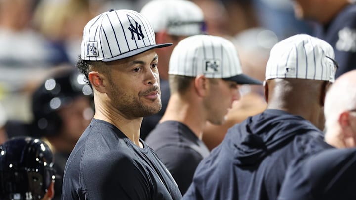 New York Yankees designated hitter Giancarlo Stanton looks on from the dugout against the Philadelphia Phillies in the sixth inning during spring training.