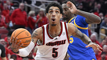 Mar 1, 2025; Louisville, Kentucky, USA;  Louisville Cardinals guard Terrence Edwards Jr. (5) drives to the basket against Pittsburgh Panthers forward Guillermo Diaz Graham (25) during the second half at KFC Yum! Center. Louisville defeated Pittsburgh 79-68. Mandatory Credit: Jamie Rhodes-Imagn Images