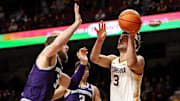 Feb 25, 2025; Minneapolis, Minnesota, USA; Minnesota Golden Gophers forward Dawson Garcia (3) shoots as Northwestern Wildcats center Matthew Nicholson (34) defends during the first half at Williams Arena. Mandatory Credit: Matt Krohn-Imagn Images