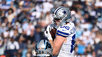 Nov 19, 2023; Charlotte, North Carolina, USA;  Dallas Cowboys tight end Luke Schoonmaker (86) catches a touchdown catch as Carolina Panthers cornerback Donte Jackson (26) defends in the first quarter at Bank of America Stadium. Mandatory Credit: Bob Donnan-Imagn Images