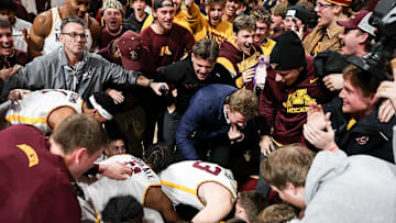 Jan 16, 2025; Minneapolis, Minnesota, USA; Minnesota Golden Gophers players and fans celebrate the teams win after the game against the Michigan Wolverines at Williams Arena. Mandatory Credit: Matt Krohn-Imagn Images