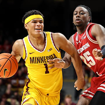 Mar 5, 2025; Minneapolis, Minnesota, USA; Minnesota Golden Gophers guard Isaac Asuma (1) works around Wisconsin Badgers guard John Blackwell (25) during the first half at Williams Arena. Mandatory Credit: Matt Krohn-Imagn Images