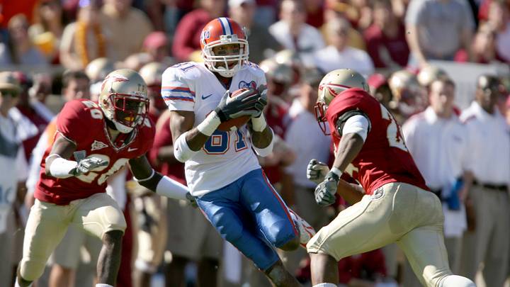 Nov 25, 2006; Tallahassee, FL, USA; Florida Gators wide receiver (81) Dallas Baker makes a catch in between Florida State Seminoles cornerback (20) Jamie Robinson and safety (24) Darius McClure during the second quarter at Doak Campbell stadium in Tallahassee, Florida. Mandatory Credit: Jason Parkhurst-USA TODAY Sports Copyright © Jason Parkhurst
