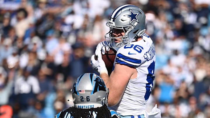 Nov 19, 2023; Charlotte, North Carolina, USA;  Dallas Cowboys tight end Luke Schoonmaker (86) catches a touchdown catch as Carolina Panthers cornerback Donte Jackson (26) defends in the first quarter at Bank of America Stadium.