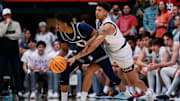 Colorado State guard Nique Clifford knocks the ball away from Utah State guard Ian Martinez.