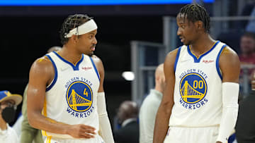 Mar 8, 2022; San Francisco, California, USA; Golden State Warriors guard Moses Moody (4) and forward Jonathan Kuminga (00) talk during the second quarter against the LA Clippers at Chase Center. Mandatory Credit: Darren Yamashita-Imagn Images