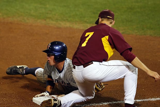 Cal State Fullerton Titans catcher Billy Marcoe (6) slides into third base ahead of the tag.