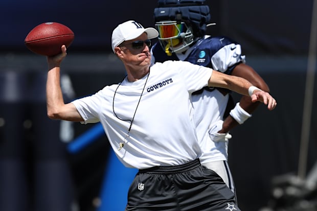 Dallas Cowboys special teams coordinator John Fassel runs a drill during training camp
