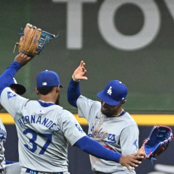 Aug 12, 2024; Milwaukee, Wisconsin, USA; Los Angeles Dodgers outfielder Teoscar Hernández (37), Los Angeles Dodgers outfielder Kevin Kiermaier (93) and Los Angeles Dodgers outfielder Mookie Betts (50) celebrate a 5-2 win over the Milwaukee Brewers at American Family Field. Mandatory Credit: Michael McLoone-USA TODAY Sports