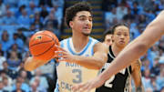 Dec 7, 2025; Chapel Hill, North Carolina, USA;  North Carolina Tar Heels guard Derek Dixon (3) looks to pass as Georgetown Hoyas guard Malik Mack (2) and forward Caleb Williams (4) defend in the second half at Dean E. Smith Center. Mandatory Credit: Bob Donnan-Imagn Images