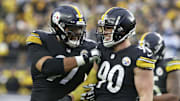 Pittsburgh Steelers defensive end Cameron Heyward and outside linebacker T.J. Watt celebrate a fumble recovery.