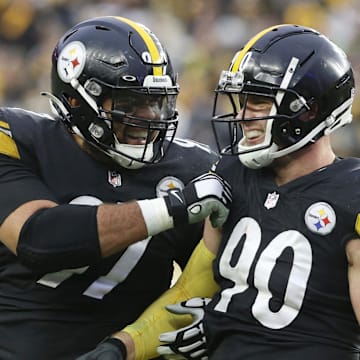 Pittsburgh Steelers defensive end Cameron Heyward and outside linebacker T.J. Watt celebrate a fumble recovery.