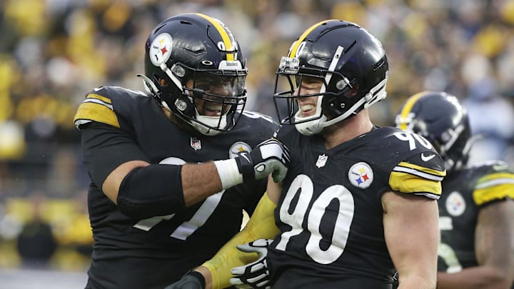 Pittsburgh Steelers defensive end Cameron Heyward and outside linebacker T.J. Watt celebrate a fumble recovery.