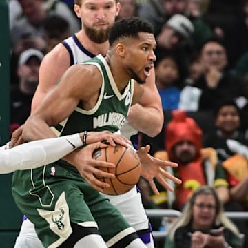 Nov 1, 2025; Milwaukee, Wisconsin, USA;  Sacramento Kings guard Russell Westbrook (18) vies for the ball against Milwaukee Bucks forward Giannis Antetokounmpo (34) in the fourth quarter at Fiserv Forum. Mandatory Credit: Benny Sieu-Imagn Images