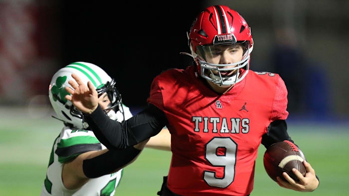 Kevin Sperry Jr. carries the ball in a state championship semi-final as Carl Albert plays McGuiness